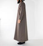 Person wearing a long brown jubba thobe