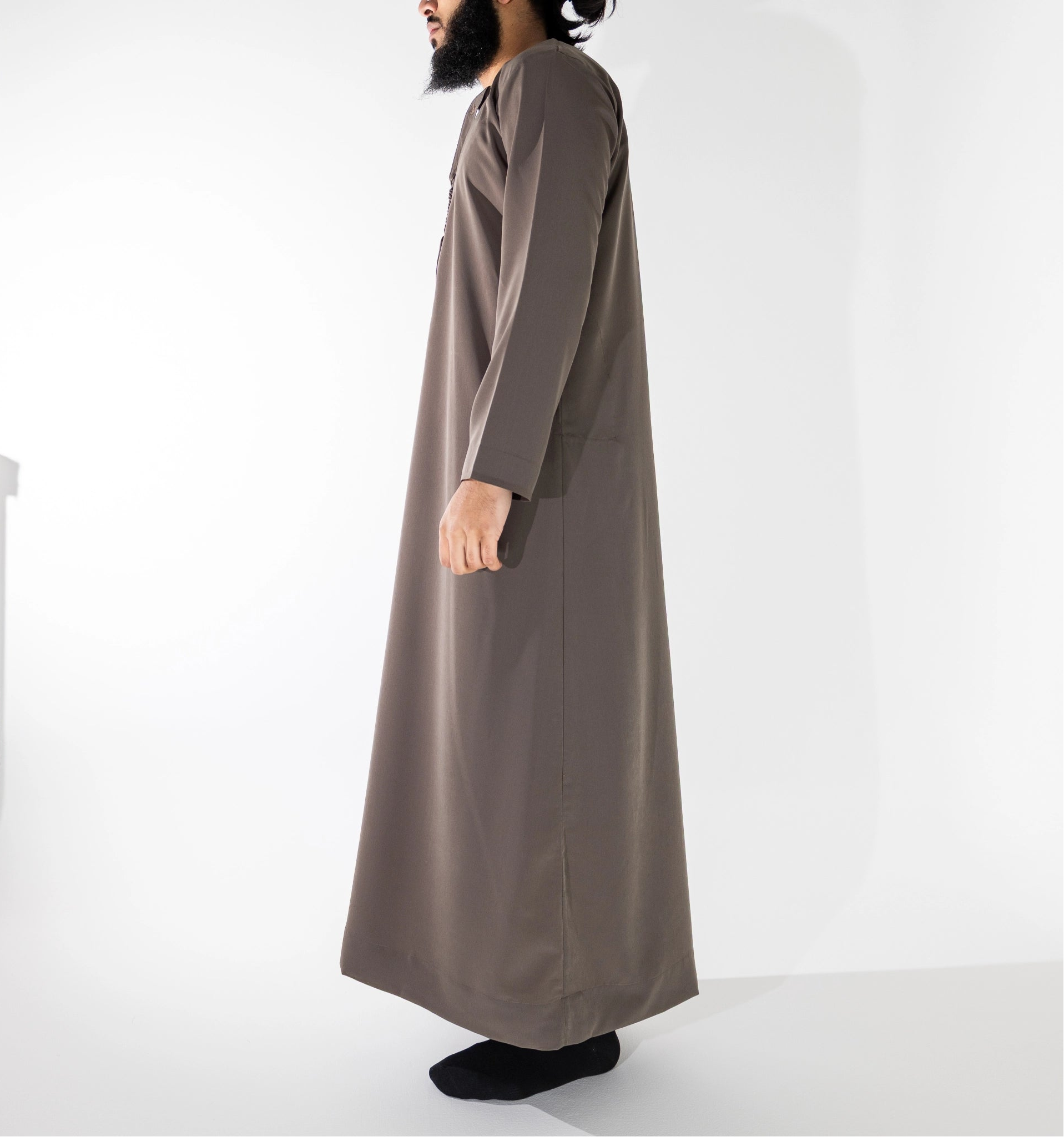 Person wearing a long brown jubba thobe