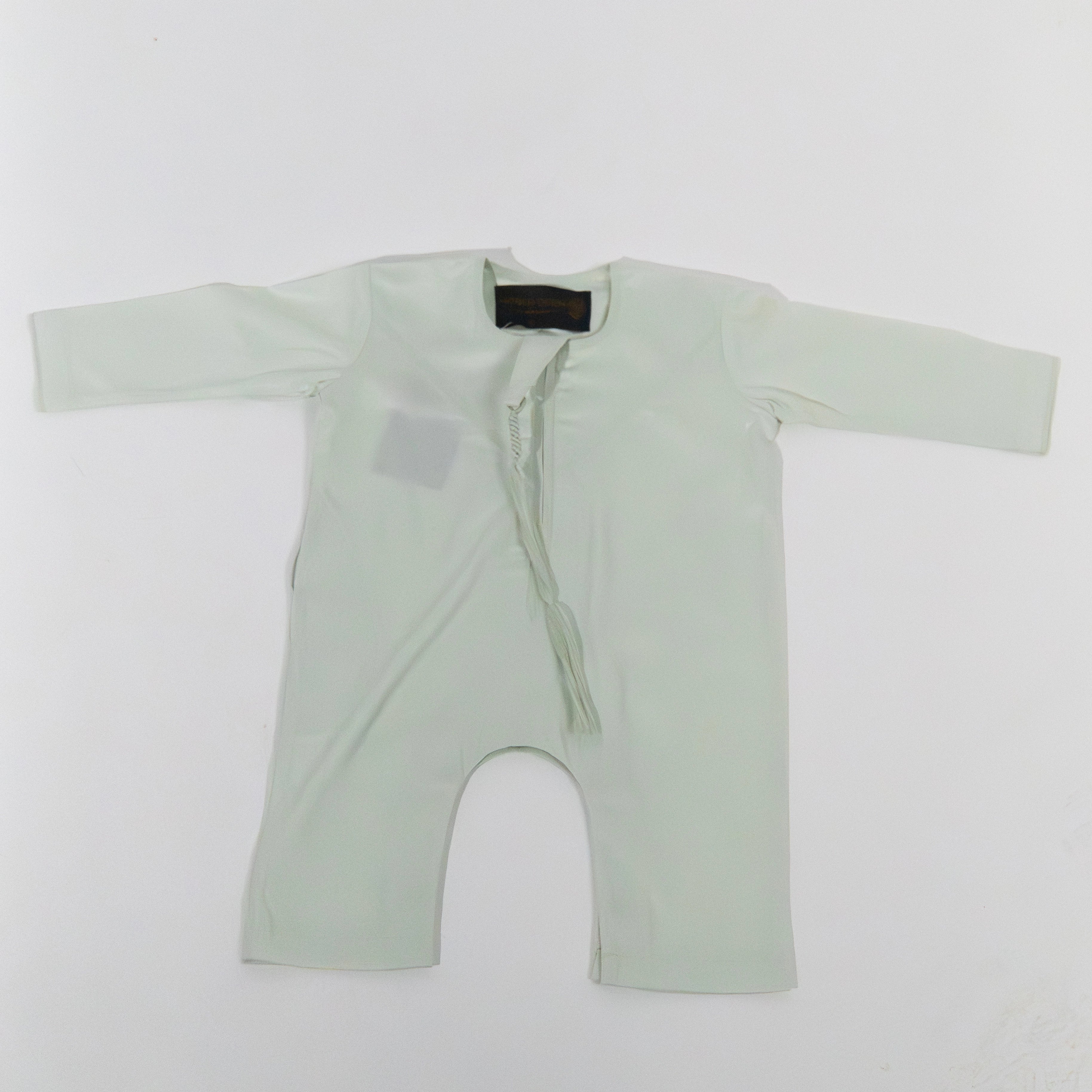 Light green baby onesie on a white background